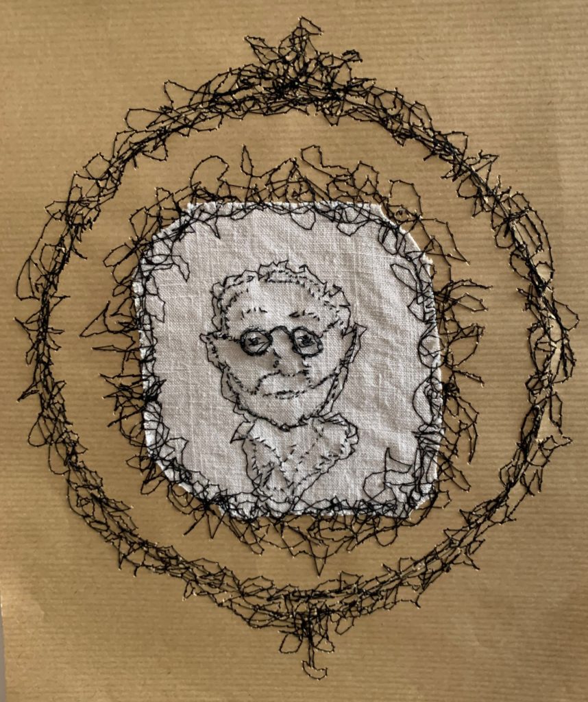 portrait d'un homme moustachu à lunettes style écrivain du 19ème siècle sur tissu de lin ancien entouré de deux rangés de broderies noires façon cadre ancien