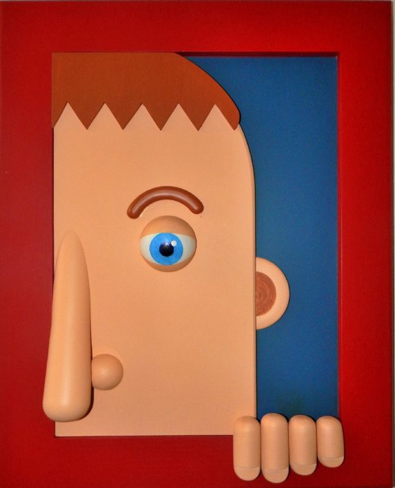 image d'un tableau en papier maché encadré de rouge réalisé par Guy Pirot qui représente une partie de visage masculin